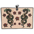 The Desert Serpent Golf Towel (24” x 16”) is a beige microfiber towel with two green snakes wrapped around axes, facing each other among red and black flowers, featuring a magnetic clip and carabiner for easy attachment.