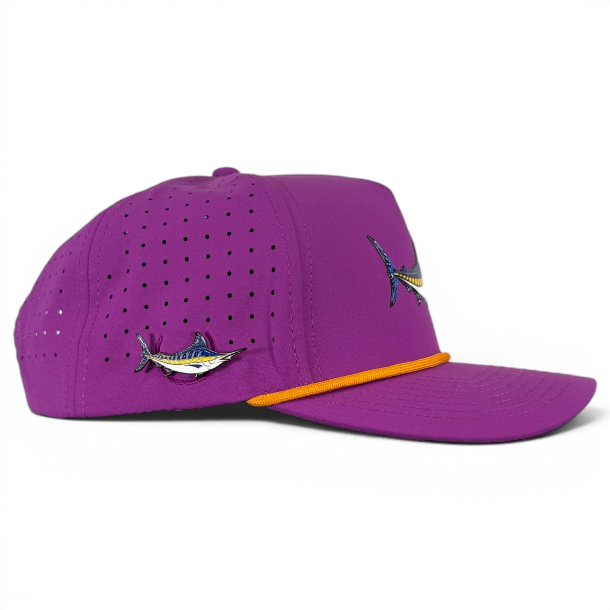 The Marlin Golf Hat is an adjustable purple snapback cap with a built-in magnetic ball marker holder and marker included, plus embroidered fish designs, ventilation holes, and an orange rope above the brim.