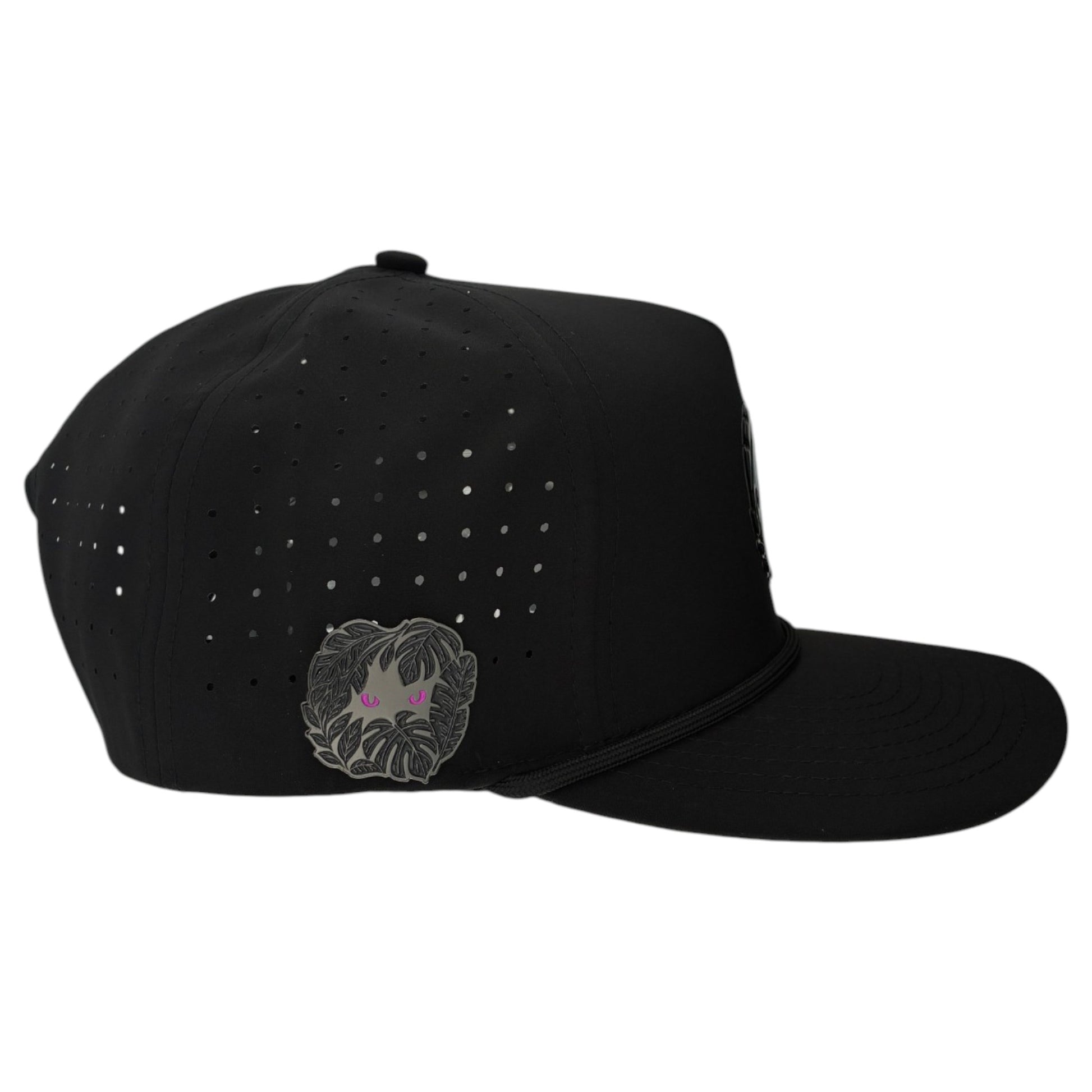 A black Night Stalker Golf Hat snapback with small side vents, an embroidered patch of a face with pink eyes and leafy beard near the back, plus a built-in magnetic ball marker holder (marker included); adjustable.