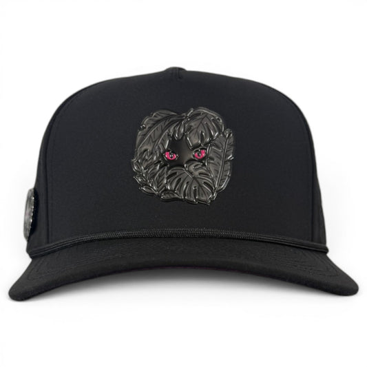 The Night Stalker Golf Hat is a black snapback cap with animal eyes, an adjustable fit, built-in magnetic ball marker holder with marker included, and stylish detailing for golfers.