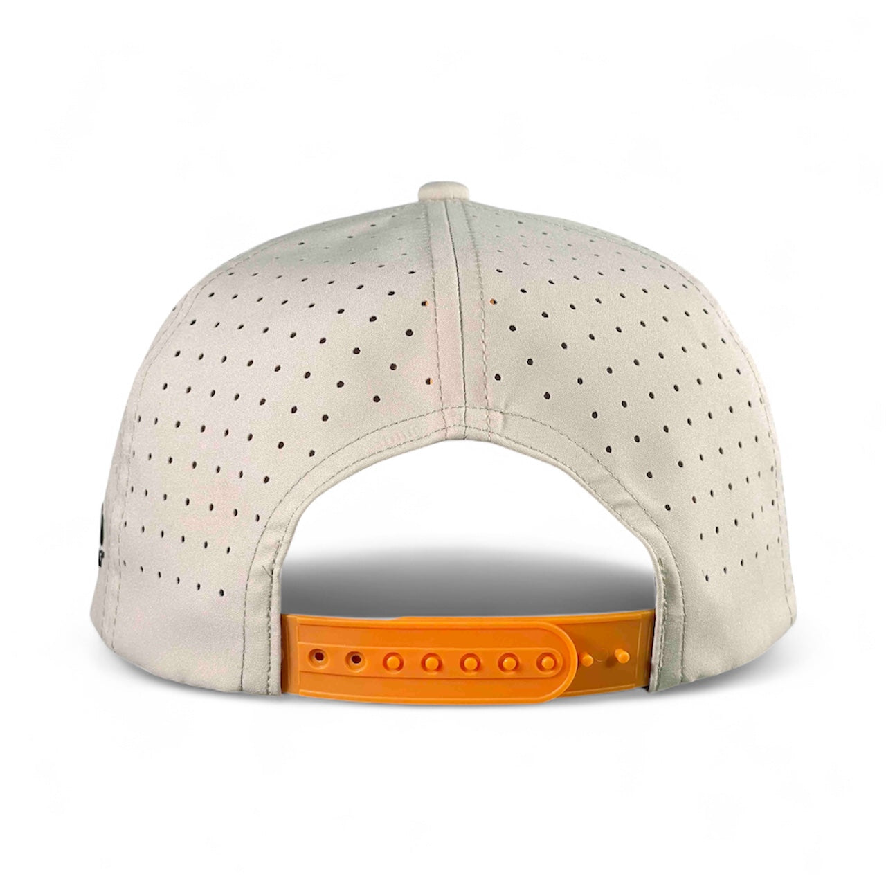 Back view of the Mulligan Tan Breakfast Ball Golf Hat—an adjustable snapback cap featuring perforated light gray panels, an orange closure, and a built-in magnetic ball marker holder (marker included), set against a white background.