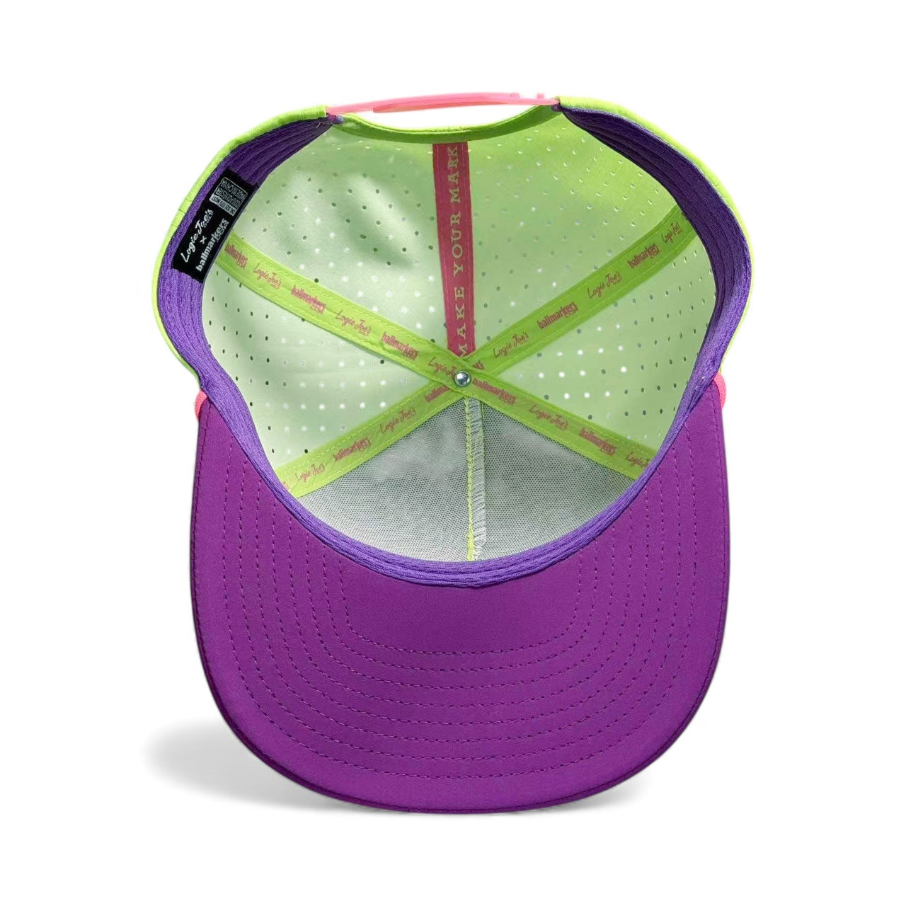 The I'd Hit That Piñata Golf Hat features a purple brim, neon green and pink accents, perforated fabric, plus a sweatband with MAKE YOUR MARK and Legit. Comes with built-in magnetic ball marker holder, marker included. Adjustable snapback.