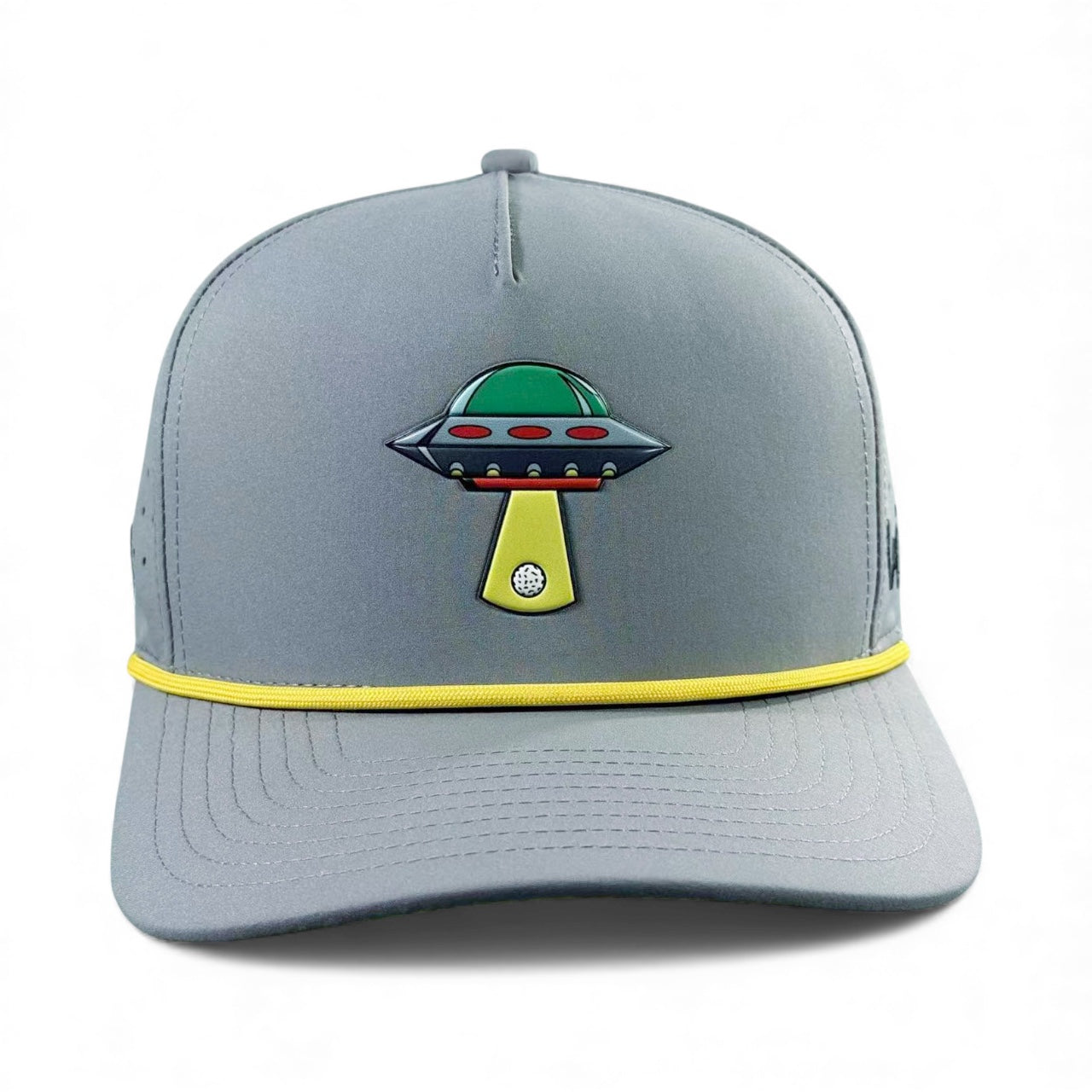 The UFO Golf Hat in Alien Gray features a colorful UFO graphic, yellow brim accent, and includes a built-in magnetic ball marker holder with marker—an adjustable snapback cap perfect for golf enthusiasts.