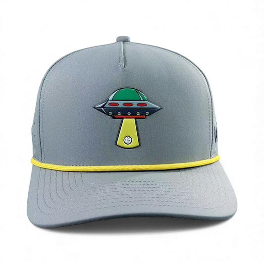 The UFO Golf Hat in Alien Gray features a colorful UFO graphic, yellow brim accent, and includes a built-in magnetic ball marker holder with marker—an adjustable snapback cap perfect for golf enthusiasts.