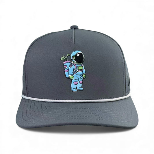 The Astronaut Walker Golf Hat is an adjustable gray snapback cap featuring a colorful astronaut design and includes a built-in magnetic ball marker holder with marker.