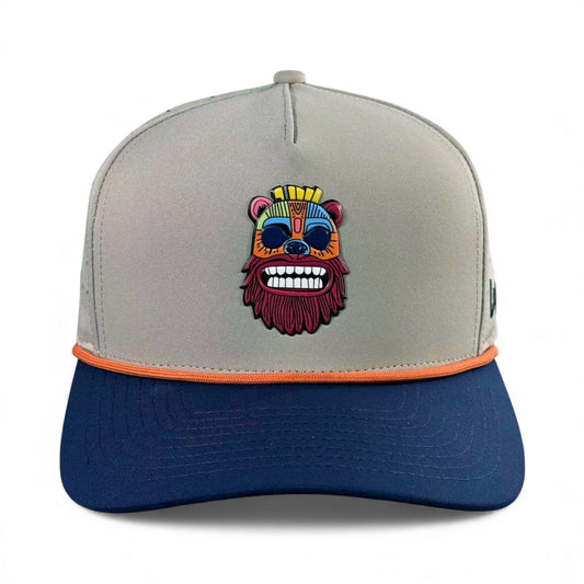 The Tiki Bear Golf Hat is a gray and navy adjustable snapback cap with a colorful embroidered bear face, orange trim, built-in magnetic ball marker holder, and includes a marker for convenience.