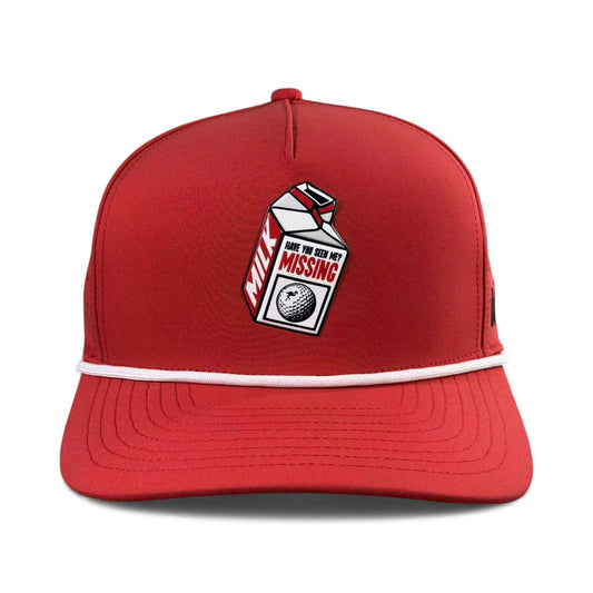The Missing Milk Golf Hat is an adjustable red snapback cap with a built-in magnetic ball marker holder and included marker, featuring a milk carton patch with a missing golf ball—your new favorite golf accessory.