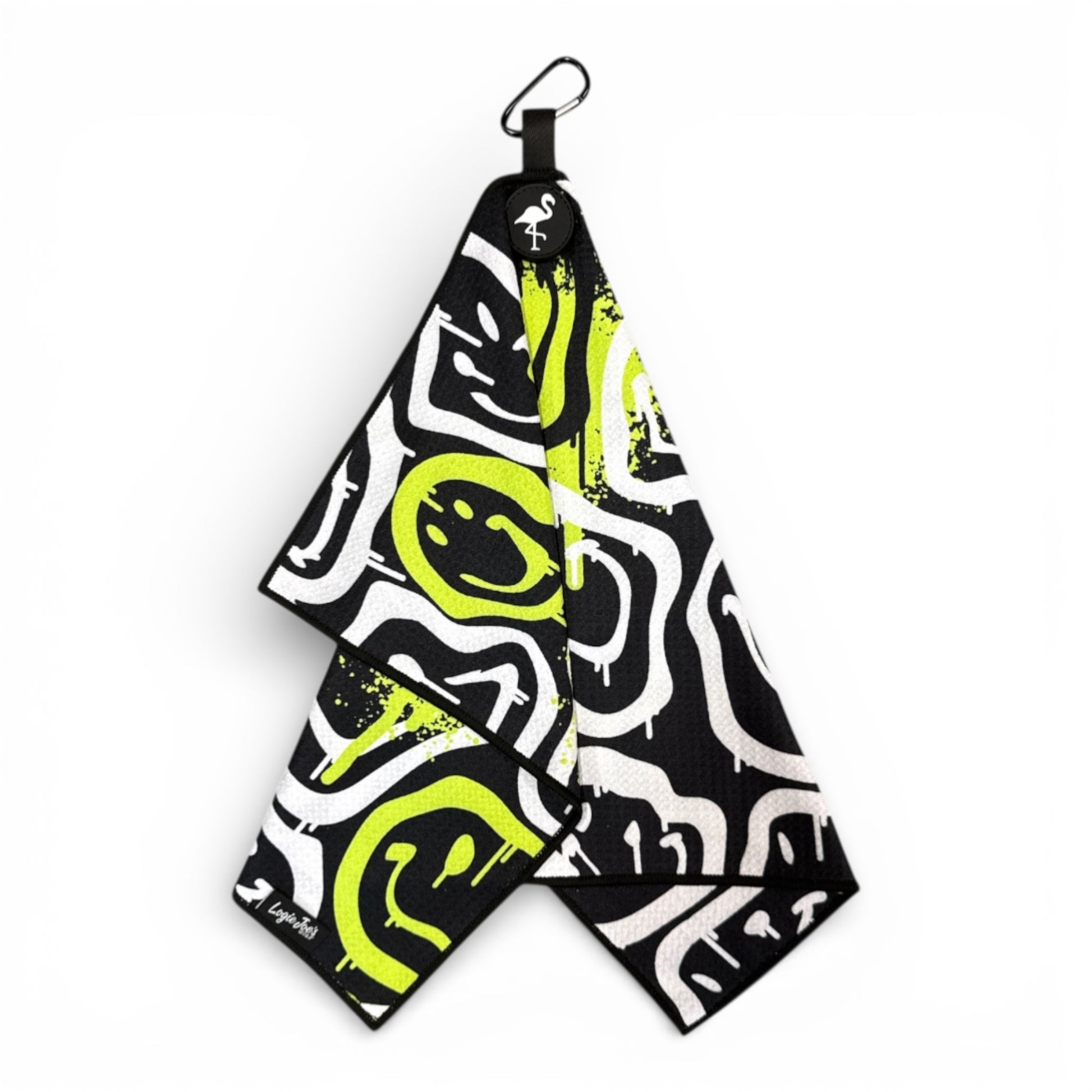 The Drippy Smile Golf Towel features black, white, and neon yellow abstract designs with graffiti-style smileys. This 24 x 16 in premium double-sided microfiber towel comes with a heavy-duty magnetic carabiner clip for easy attachment.