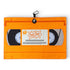 The Nostalgic 90s VHS Golf Towel is an orange, double-sided microfiber towel (24x16 in) with a heavy-duty magnetic carabiner clip, designed to look like a vintage “Logic Joes” VHS tape with illustrated tape reels.