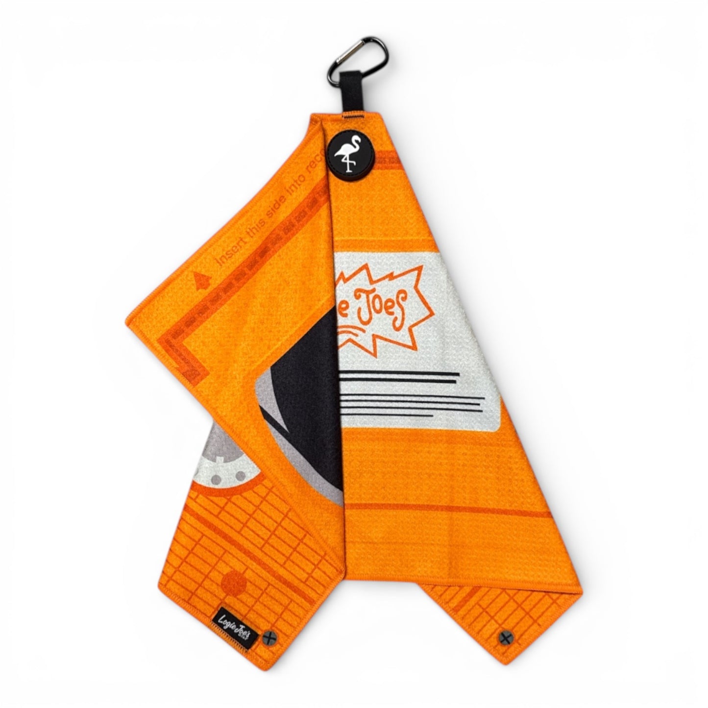 The Nostalgic 90s VHS Golf Towel is a 24 x 16 in premium double-sided microfiber towel with a geometric orange and white retro design, black carabiner clip, flamingo logo tag, Joe Joes label, and heavy-duty magnetic attachment.