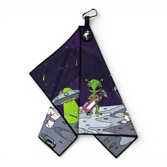 The Mission to Pars Golf Towel is a 24x16 in, premium double-sided microfiber towel featuring an astronaut and UFO design, with a heavy-duty magnetic attachment and carabiner clip—perfect for space-loving golfers.