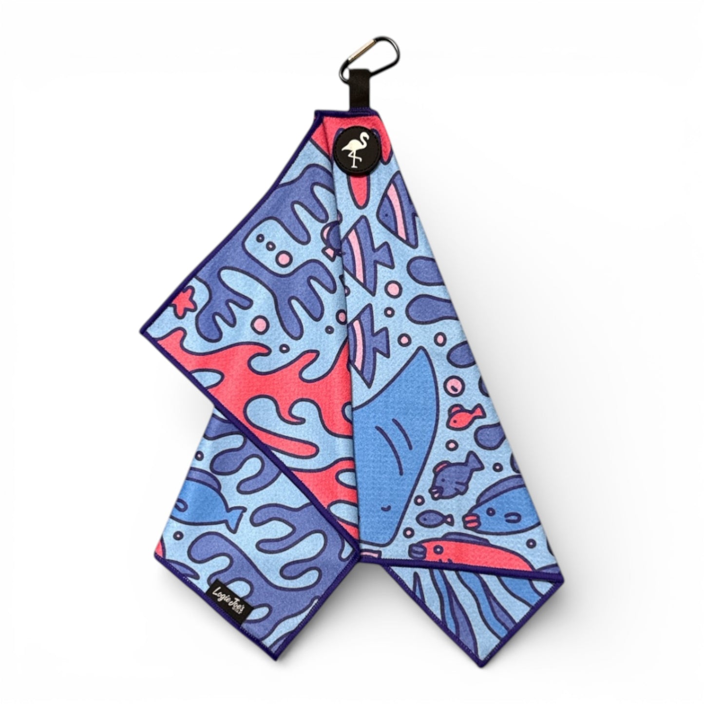 The Coral Reef Golf Towel features a vibrant marine design, is made of premium double-sided microfiber, measures 24 x 16 in, and includes a heavy-duty magnetic carabiner clip for easy hanging.