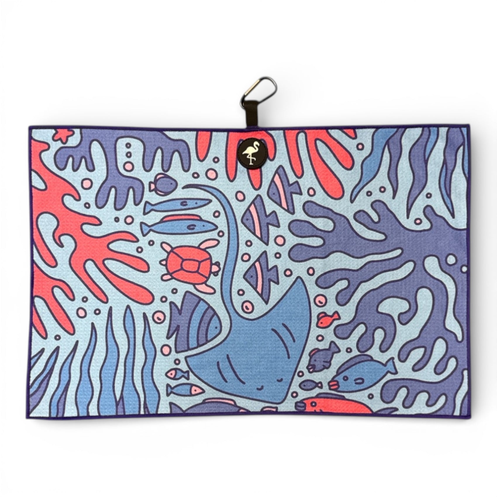The Coral Reef Golf Towel is a 24 x 16 in premium double-sided microfiber towel featuring a vibrant underwater scene. It includes a heavy-duty magnetic attachment and carabiner clip for easy use on the course.