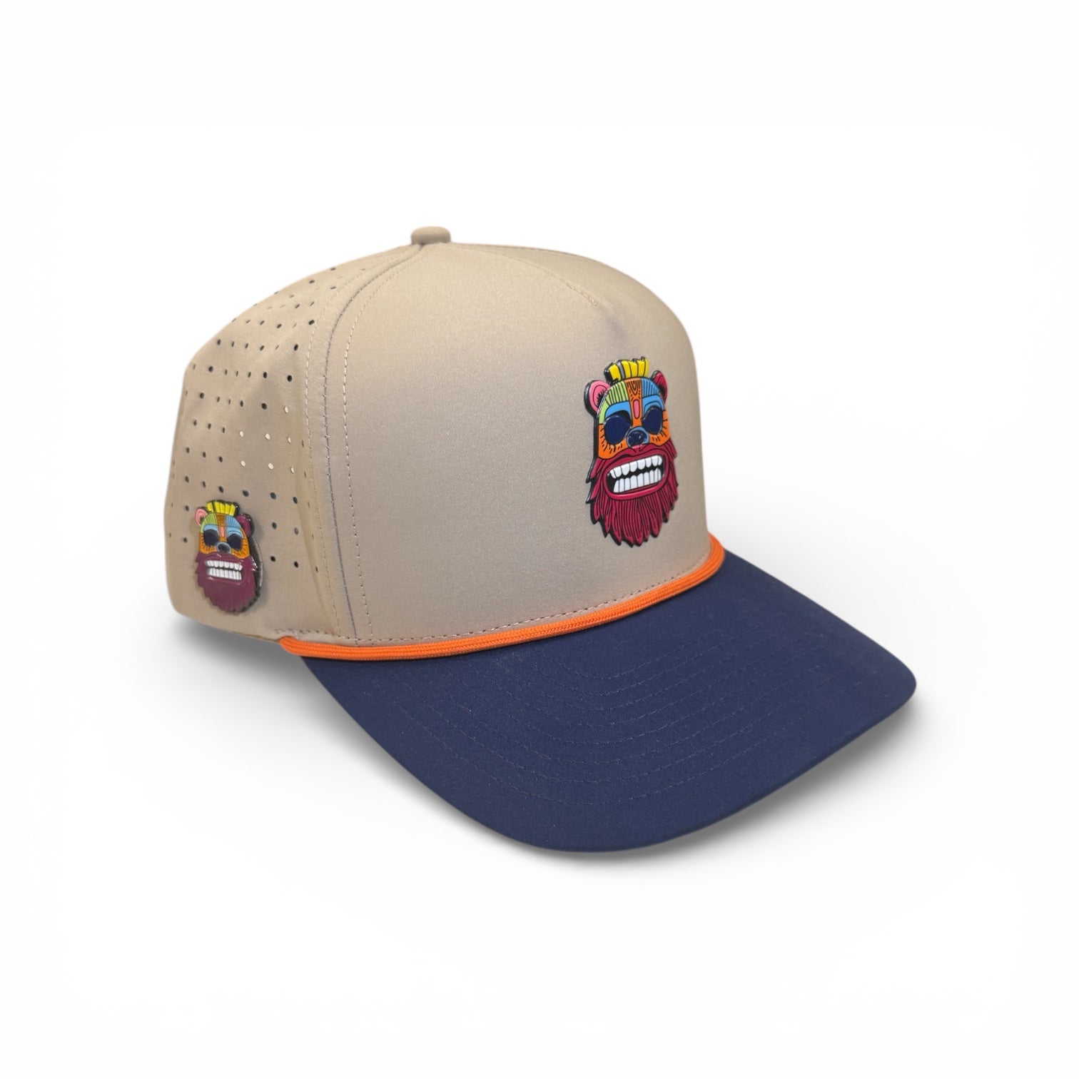 The Tiki Bear Golf Hat is an adjustable multicolor snapback cap with a vibrant bear face design, perforations for ventilation, and a built-in magnetic ball marker holder with marker included.