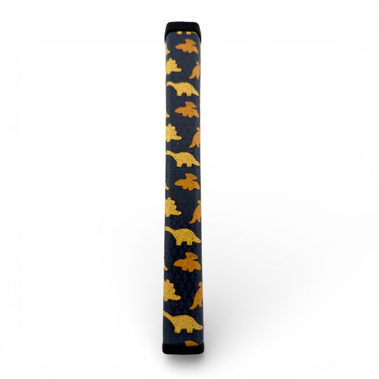 A Dino Nugget Putter Grip (2.0 Pistol Grip) made of premium PU material with a soft, tacky feel is shown upright, featuring a yellow and orange dinosaur nugget design on its spine against a white background.