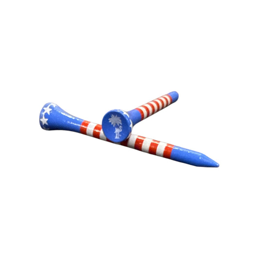 Two USA Stripe Premium Wooden Golf Tees (2 3/4”), painted with stars, stripes, and a white palm tree, display unique flag-inspired designs. The tees are crossed on a white background. Set includes 45 durable wooden tees.