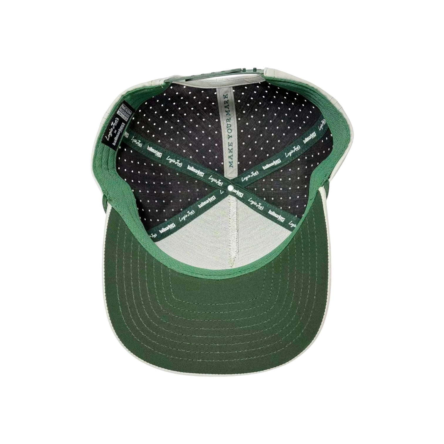 American Camo Tactical Golf Hat with adjustable snapback, built-in magnetic ball marker holder (marker included), “MAKE IT YOUR MARK” printed inside, black and gray polka dot lining, and green brim with white stitching.