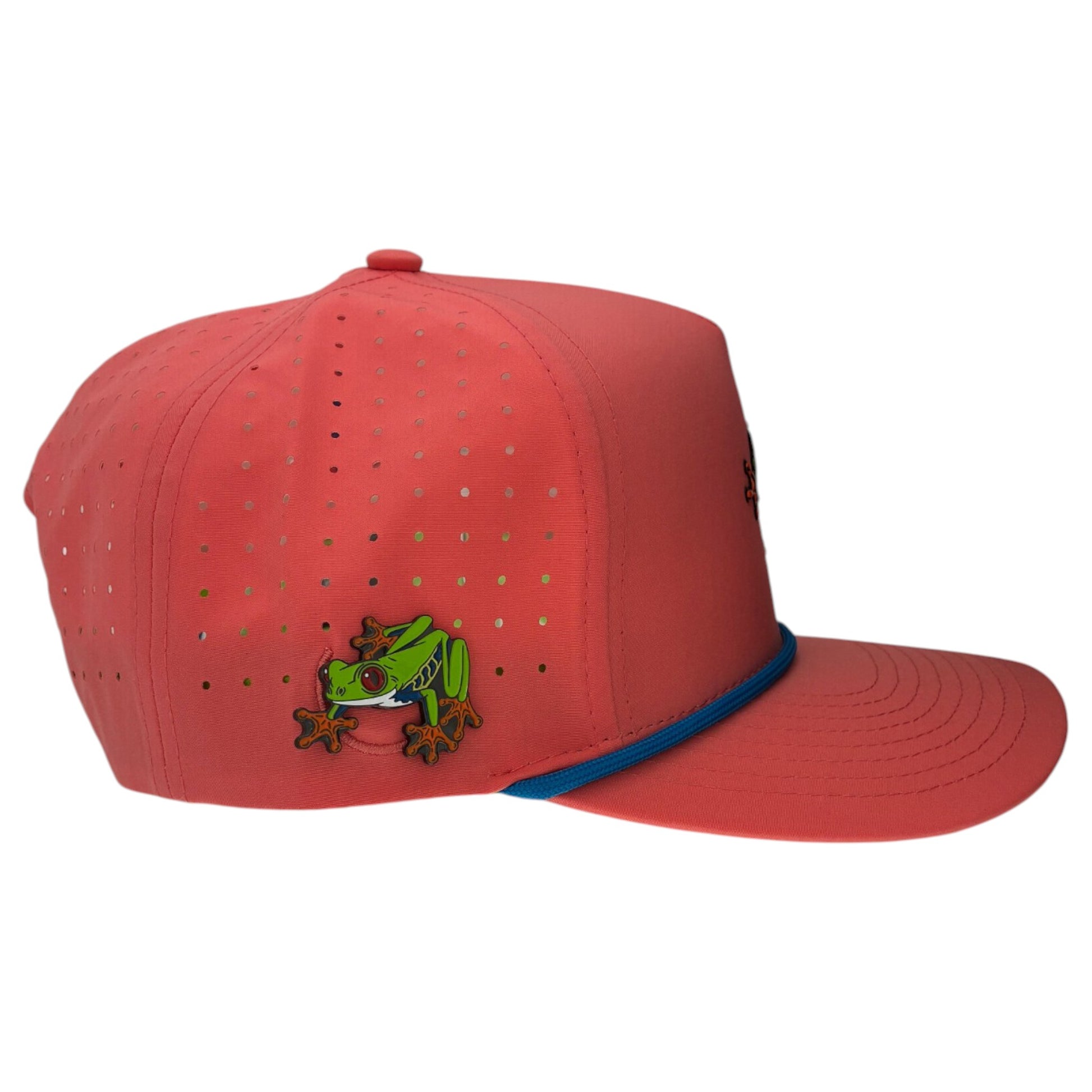 The Tree Frog Golf Hat is a bright coral-red snapback cap with blue trim, small ventilation holes, a green red-eyed tree frog embroidery, and a built-in magnetic ball marker holder with marker included. Adjustable fit.