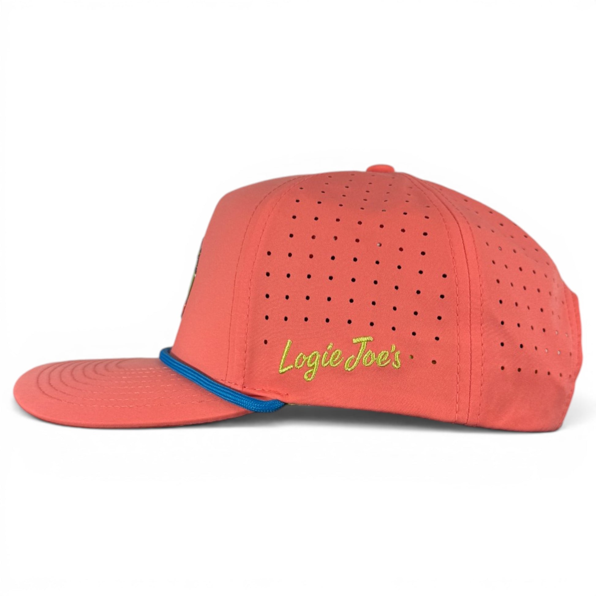 The Tree Frog Golf Hat is a snapback cap with built-in magnetic ball marker holder (marker included), small side ventilation holes, blue trim, and "Logie Joes" embroidered in yellow-green on the side. Adjustable; red-eyed design.